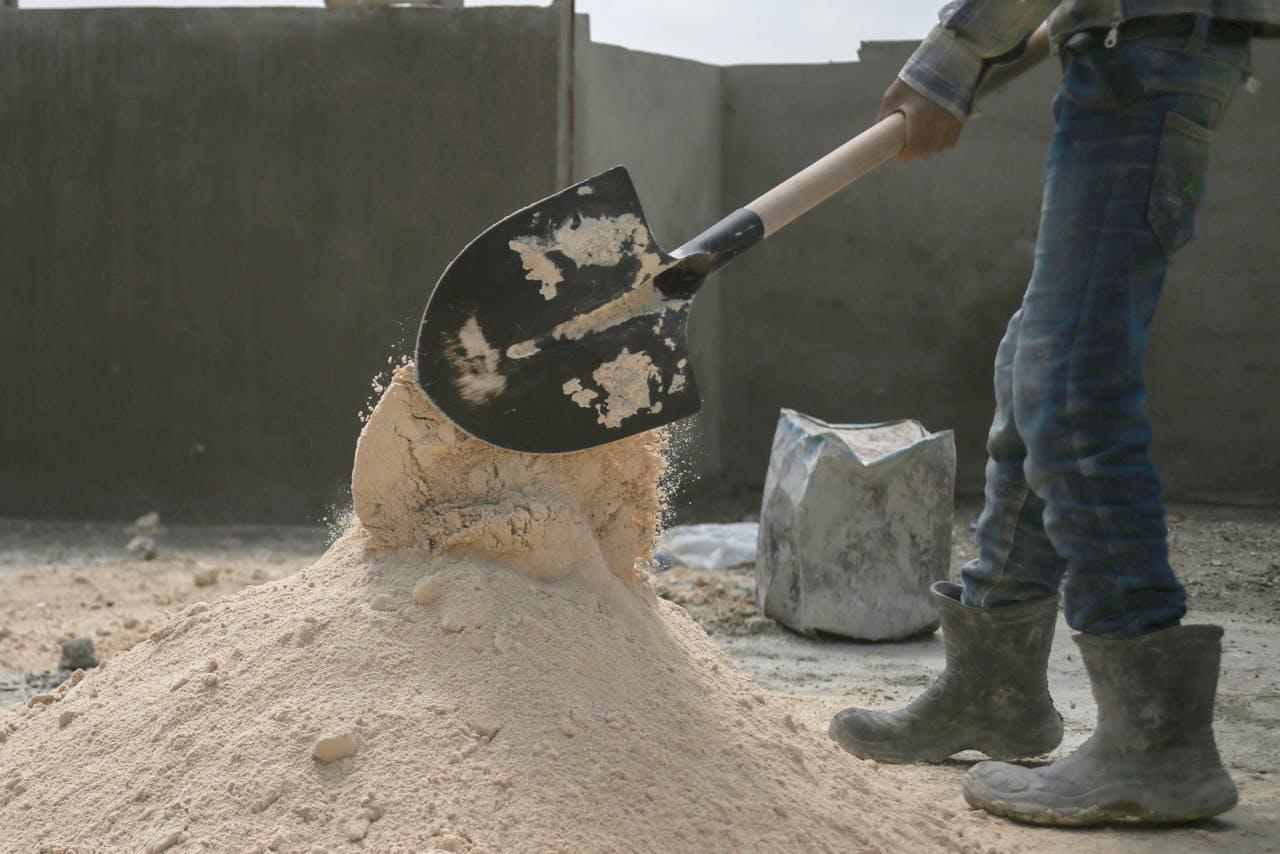 man shoving sand